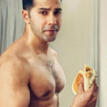 Varun Dhawan chomps on burgers, flaunts his abs on ‘cheat day’